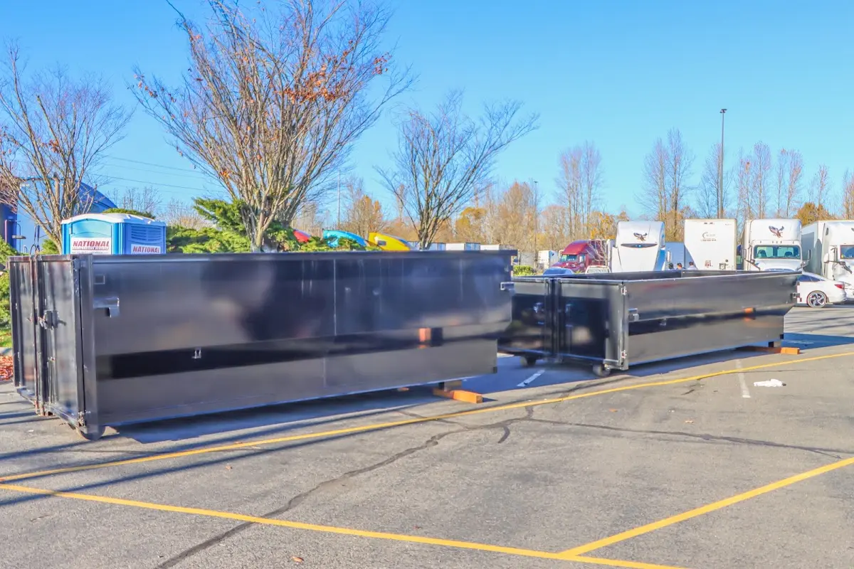 Professional dumpster rental service with roll-off container on residential driveway in West Norriton